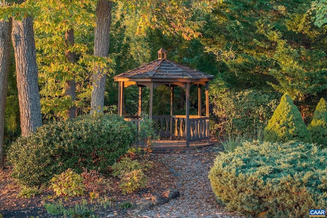 exterior space with a forest view and a gazebo