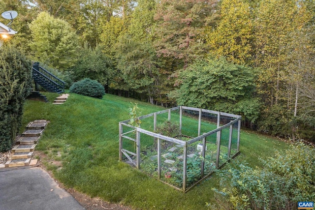 view of yard featuring a garden and stairs