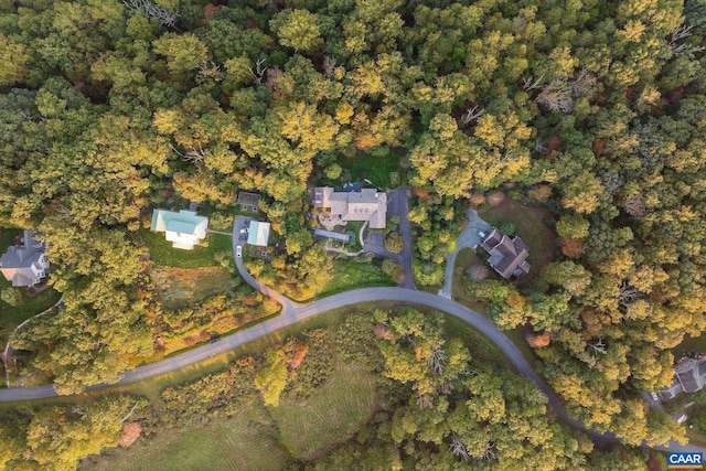 drone / aerial view featuring a wooded view