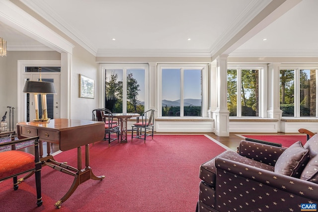 sunroom / solarium featuring decorative columns