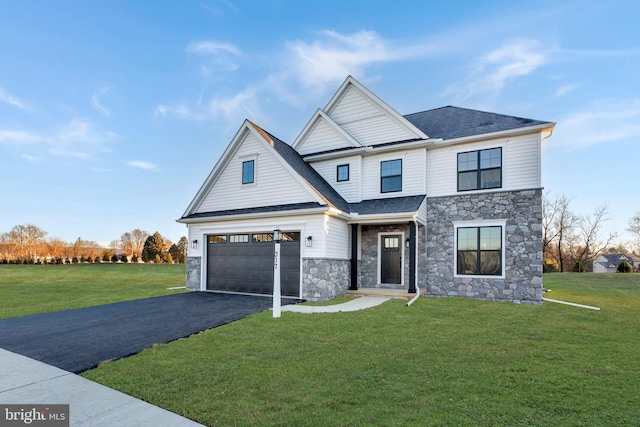 view of front facade featuring driveway, stone siding, roof with shingles, an attached garage, and a front lawn