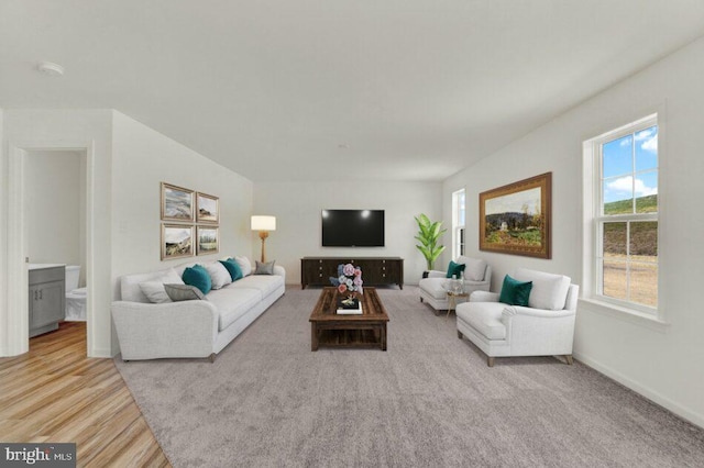 living room featuring light wood-type flooring and baseboards