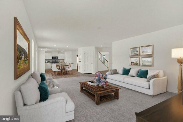 living area featuring stairs, wood finished floors, and recessed lighting