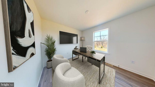office space with wood finished floors and baseboards