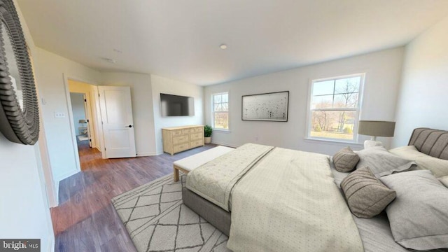bedroom with wood finished floors and baseboards