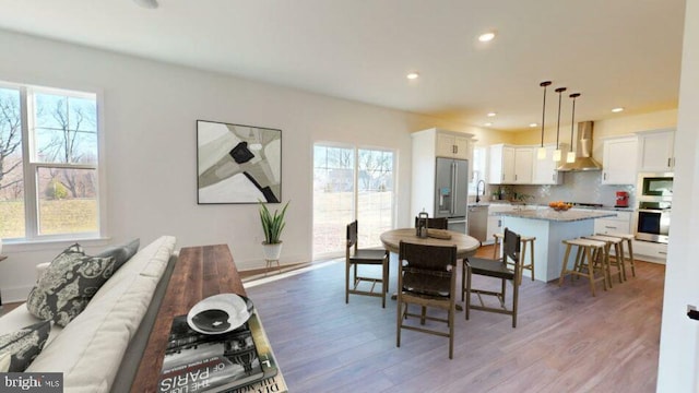 dining room featuring light wood-style flooring and recessed lighting