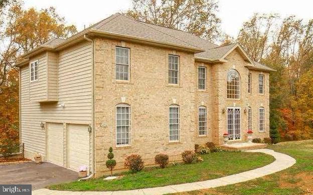 view of side of home with aphalt driveway and an attached garage