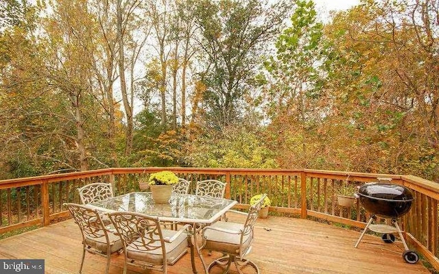 wooden terrace with outdoor dining space