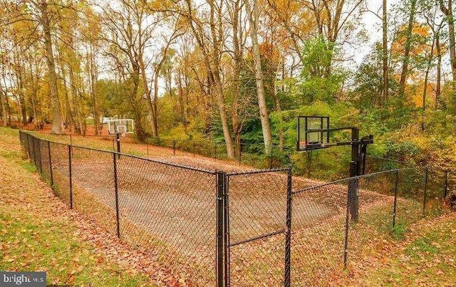 view of basketball court featuring community basketball court and fence