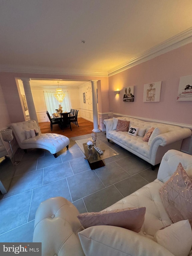 living room featuring decorative columns, ornamental molding, and tile patterned floors