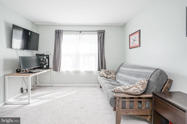 living area with light carpet and baseboards