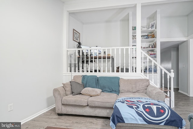 interior space featuring stairs, wood finished floors, and baseboards