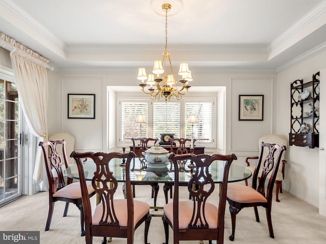 dining room featuring a wealth of natural light, a raised ceiling, and light colored carpet