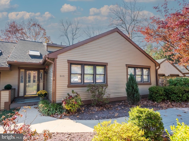 view of front of home with a shingled roof