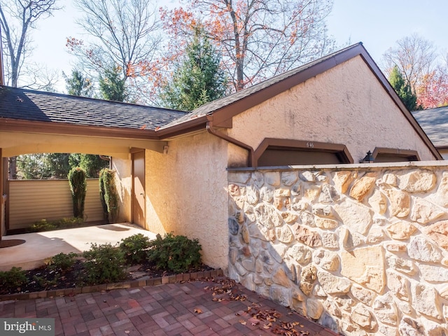 view of side of home with stucco siding