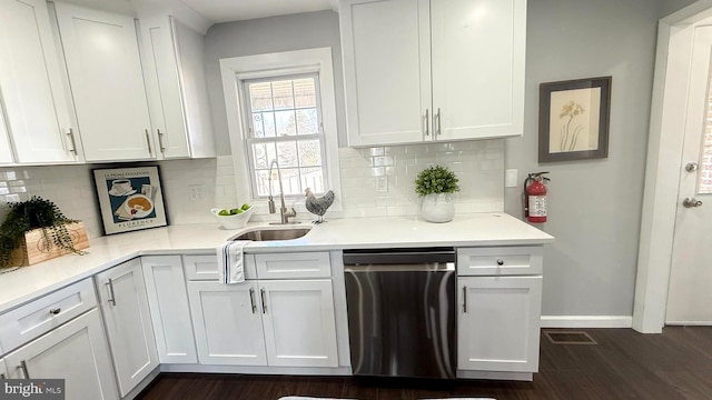 kitchen with light countertops, white cabinetry, and dishwasher