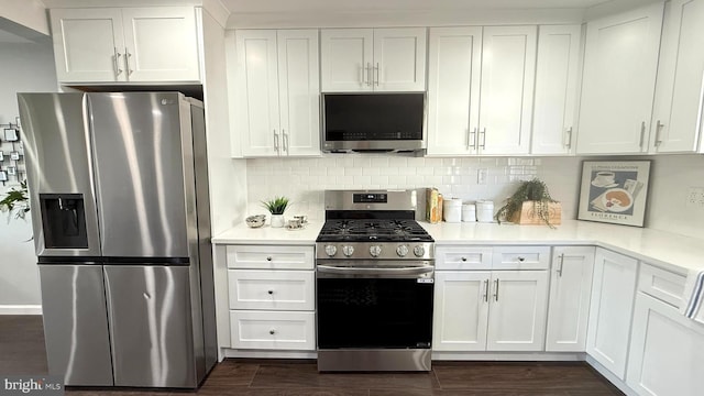 kitchen featuring white cabinets, tasteful backsplash, appliances with stainless steel finishes, and light countertops