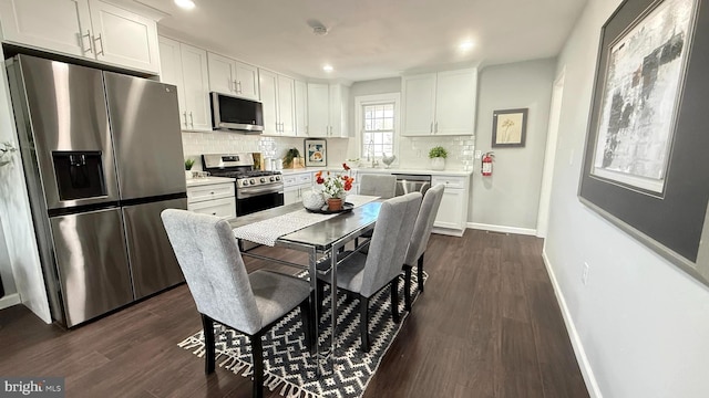 kitchen with light countertops, appliances with stainless steel finishes, backsplash, and white cabinets