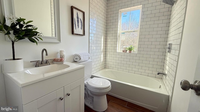 bathroom with bathing tub / shower combination, vanity, toilet, and wood finished floors