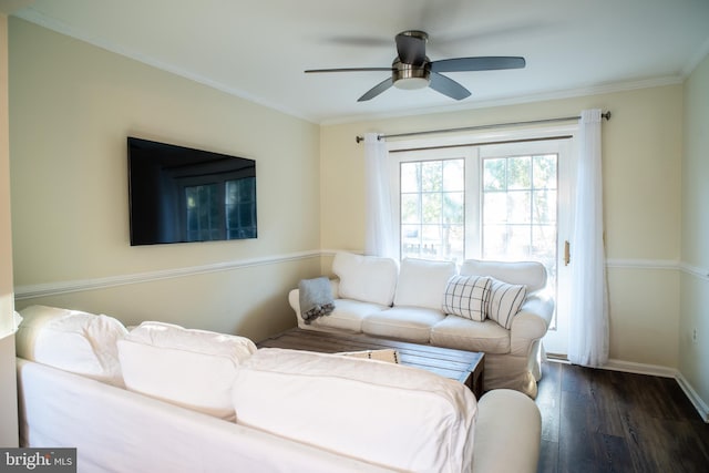 living room with ceiling fan, crown molding, baseboards, and wood finished floors