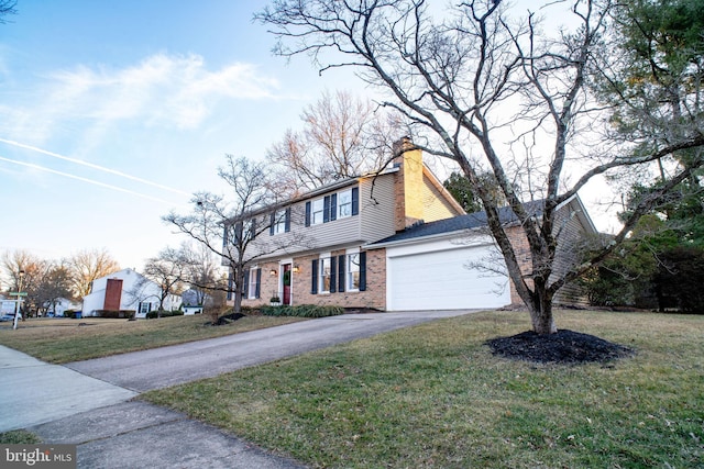 colonial inspired home with aphalt driveway, a garage, brick siding, a front lawn, and a chimney