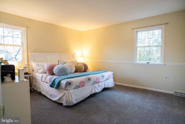 carpeted bedroom featuring visible vents and baseboards