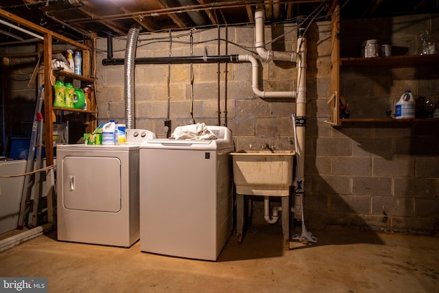 laundry area with laundry area, a sink, and independent washer and dryer