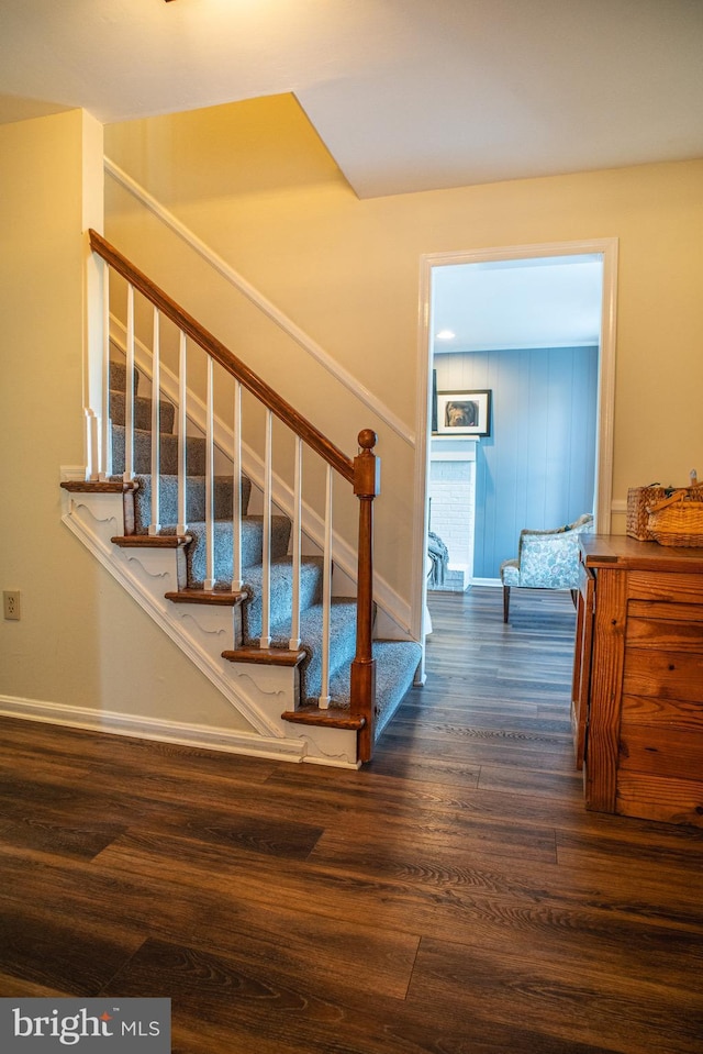 stairs featuring baseboards and wood finished floors