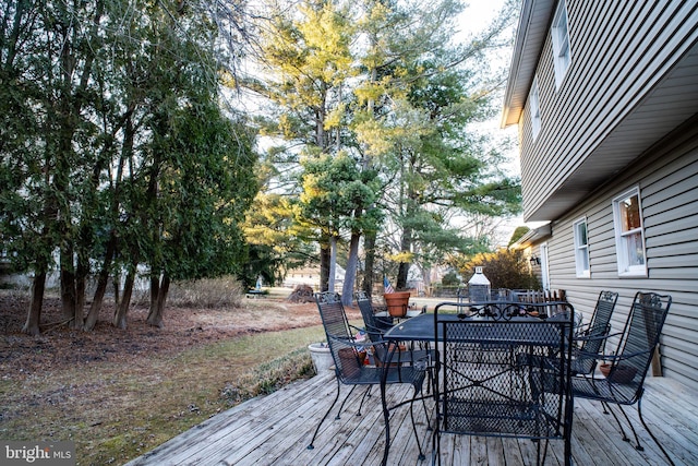 wooden terrace with outdoor dining area