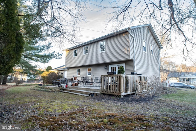 back of house with a deck