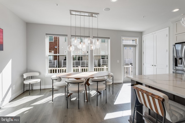 dining room with recessed lighting, wood finished floors, and baseboards