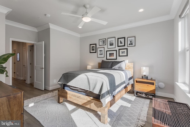 bedroom featuring ornamental molding, baseboards, and wood finished floors