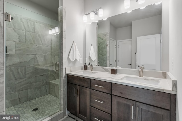 bathroom featuring double vanity, a sink, and a shower stall