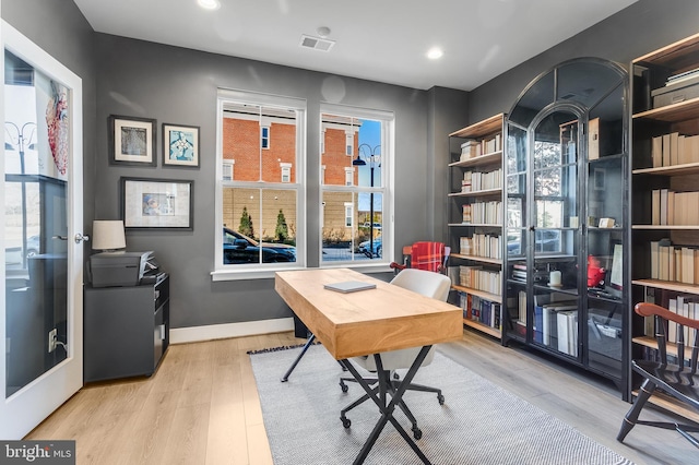 office space featuring recessed lighting, wood finished floors, visible vents, and baseboards