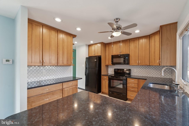 kitchen with decorative backsplash, a sink, ceiling fan, dark stone countertops, and black appliances