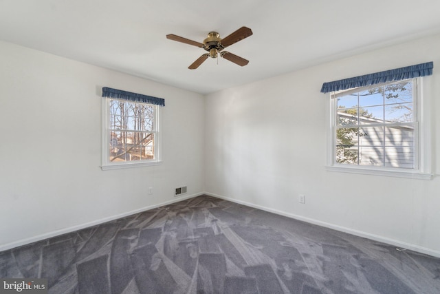 carpeted empty room with visible vents, ceiling fan, and baseboards