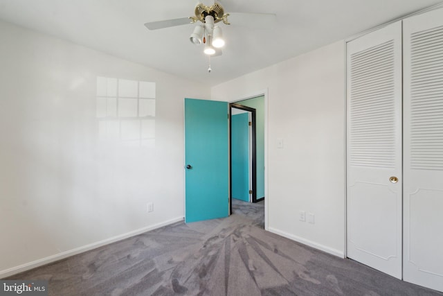 unfurnished bedroom featuring baseboards, a ceiling fan, vaulted ceiling, carpet floors, and a closet