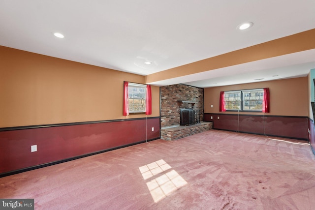 unfurnished living room featuring a fireplace, carpet flooring, and recessed lighting