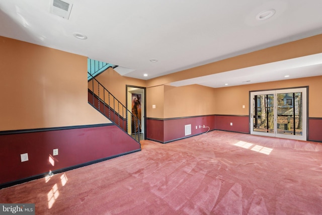 empty room featuring carpet floors, recessed lighting, visible vents, and stairs