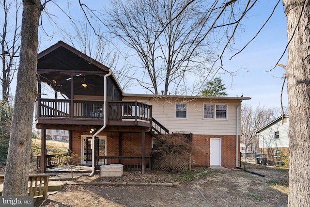 rear view of house with a wooden deck, stairway, and brick siding