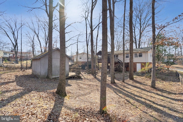 view of yard featuring an outbuilding and a wooden deck