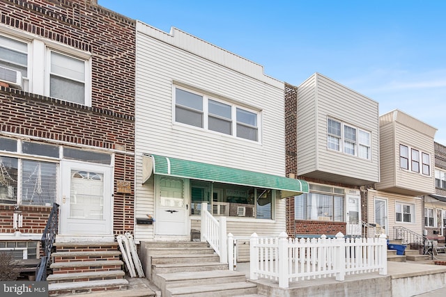 townhome / multi-family property featuring entry steps and brick siding