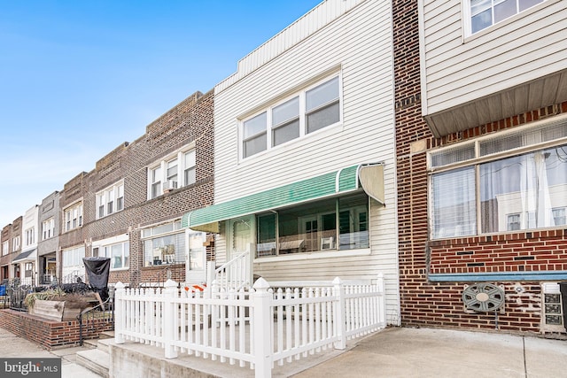 townhome / multi-family property featuring brick siding