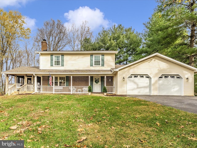 view of front of house with driveway, a garage, a front yard, a porch, and brick siding