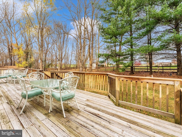 wooden terrace featuring outdoor dining area