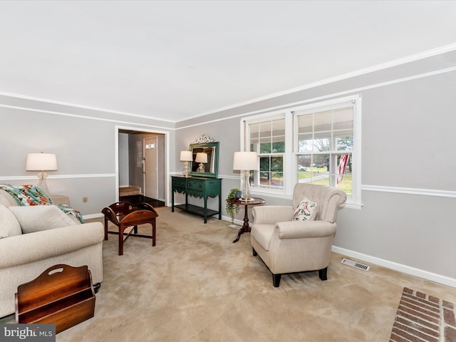 living room featuring baseboards, crown molding, visible vents, and light colored carpet