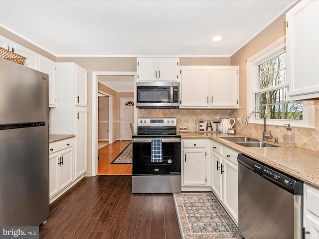 kitchen with white cabinetry, appliances with stainless steel finishes, and a sink