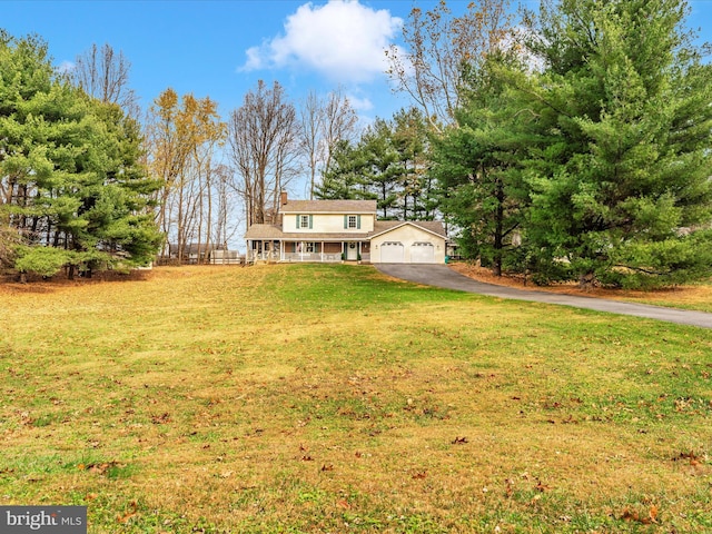 view of front of property with a garage, a front yard, driveway, and a chimney