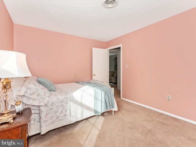 bedroom featuring light carpet, baseboards, and visible vents