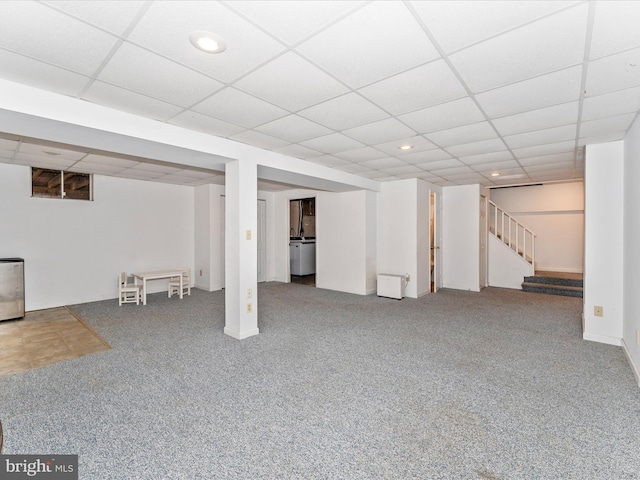 finished below grade area featuring a paneled ceiling, carpet flooring, stairway, and recessed lighting